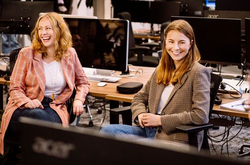 Two Karbon team members talking in an office.